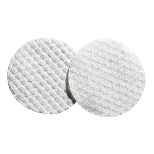 Complexion pads showing the front with waffled texture and a smoother back